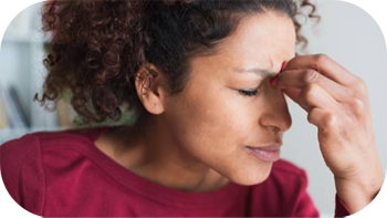 Young woman rubbing her sinuses for relief.