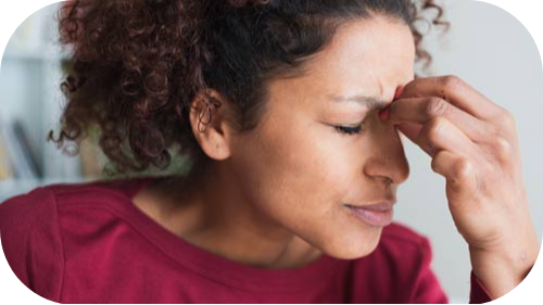 Young woman rubbing her sinuses for relief.