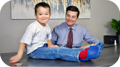 Thomas Willim and young boy smiling at camera.